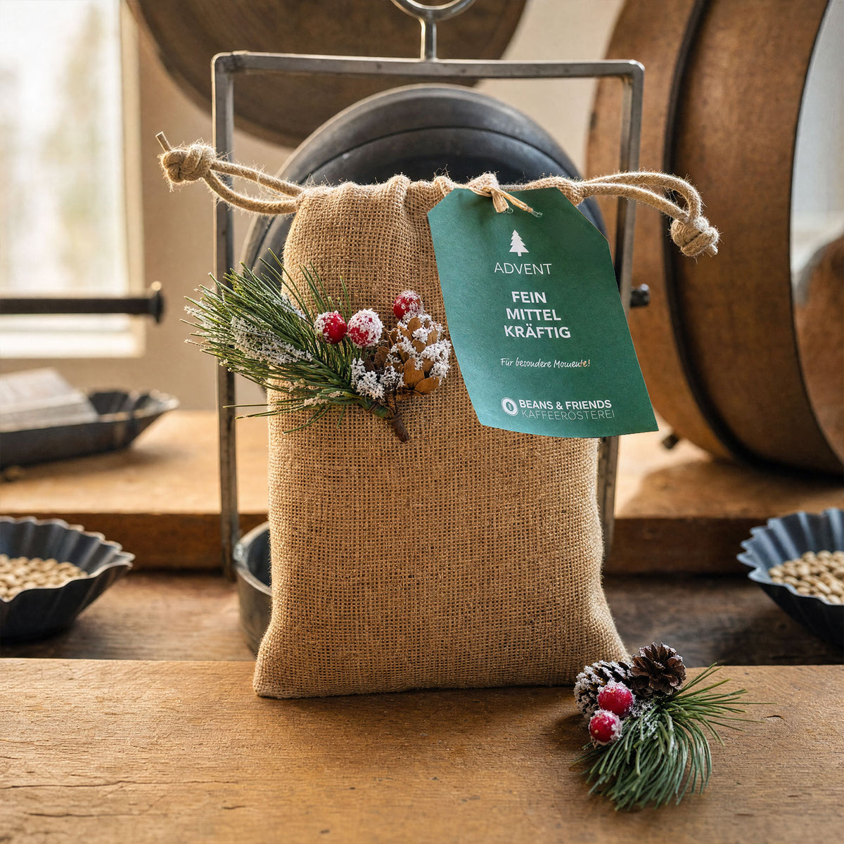 Kleines Adventspaket von Beans & Friends im Jutebeutel mit grünem Anhänger und weihnachtlicher Dekoration.